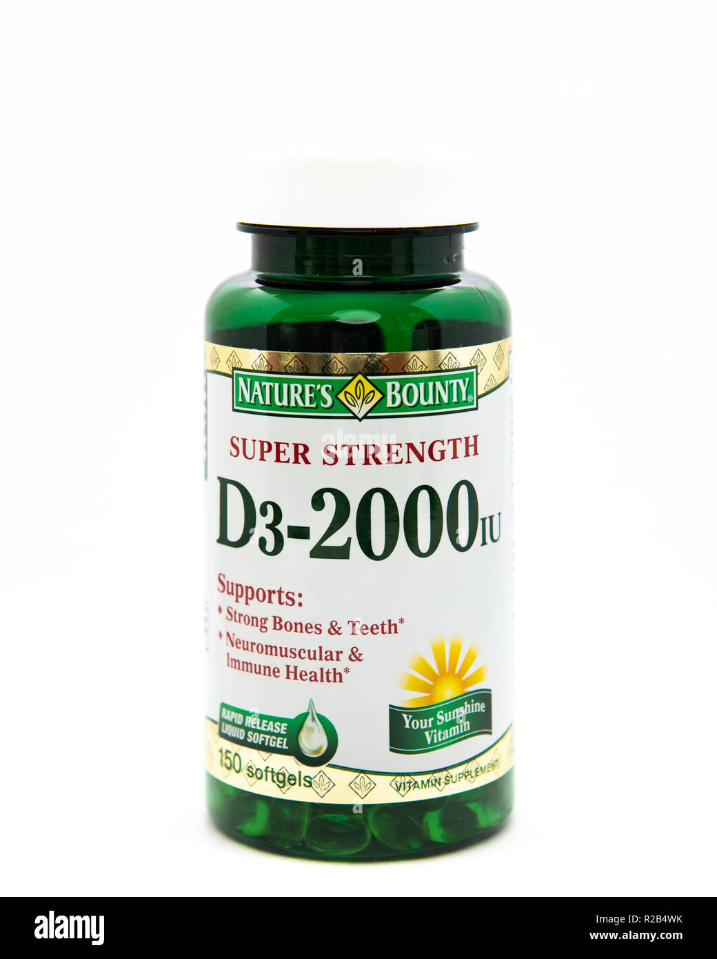 A green plastic bottle of super strength vitamin D3 softgels for strong bones & teeth and neuromuscular & immune system health supplements. Stock Photo