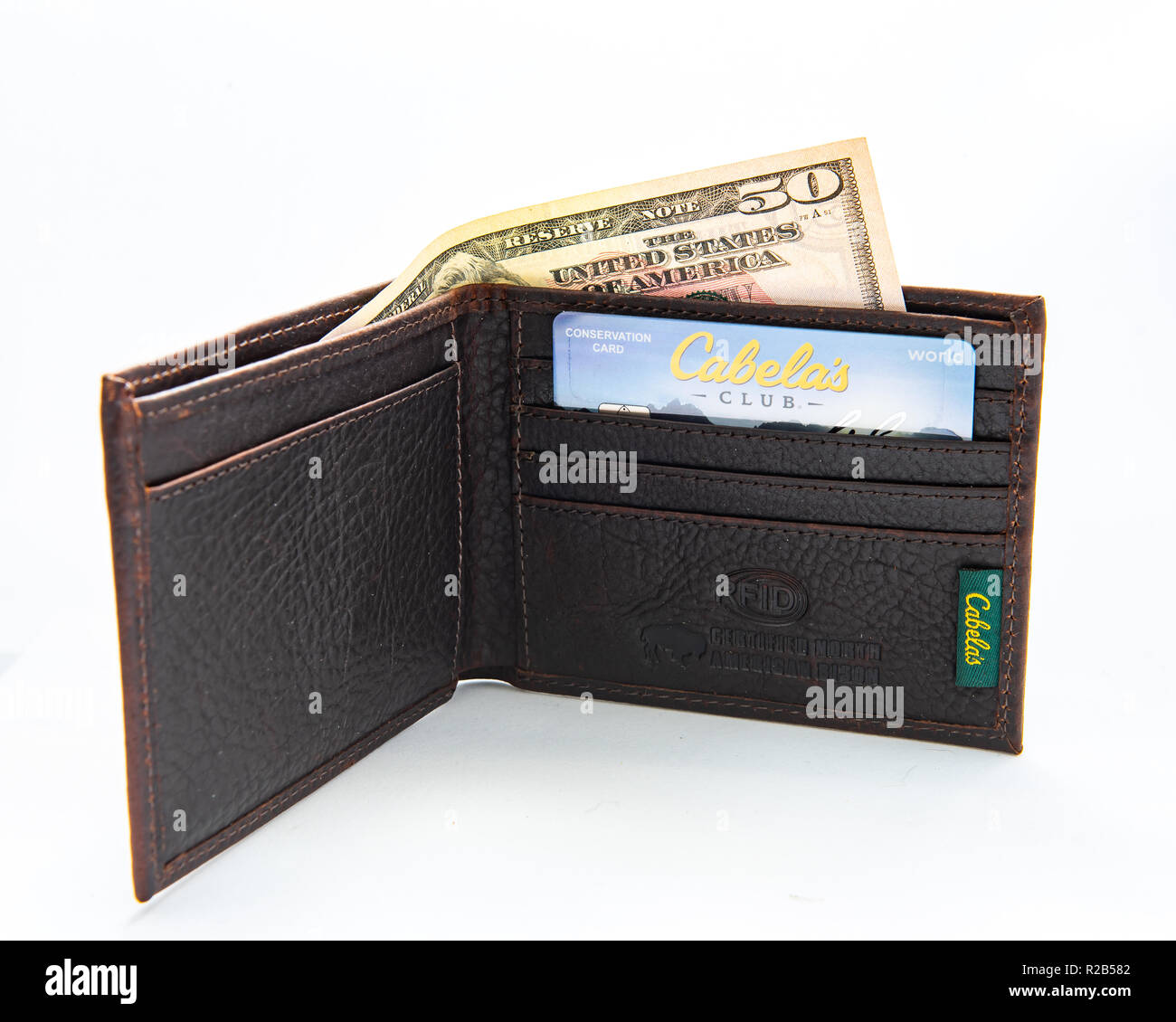 A new leather wallet from Cabela's with a Cabela's Club credit card and a 50 dollar bill. Stock Photo