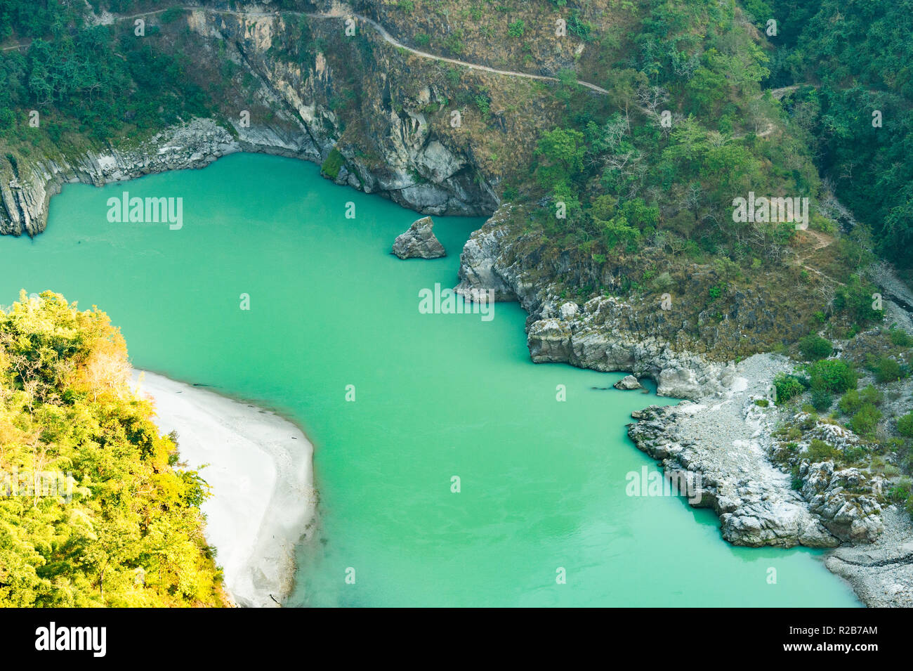 Spectacular view of the sacred Ganges river flowing through the green mountains of Rishikesh, Uttarakhand, India. Stock Photo