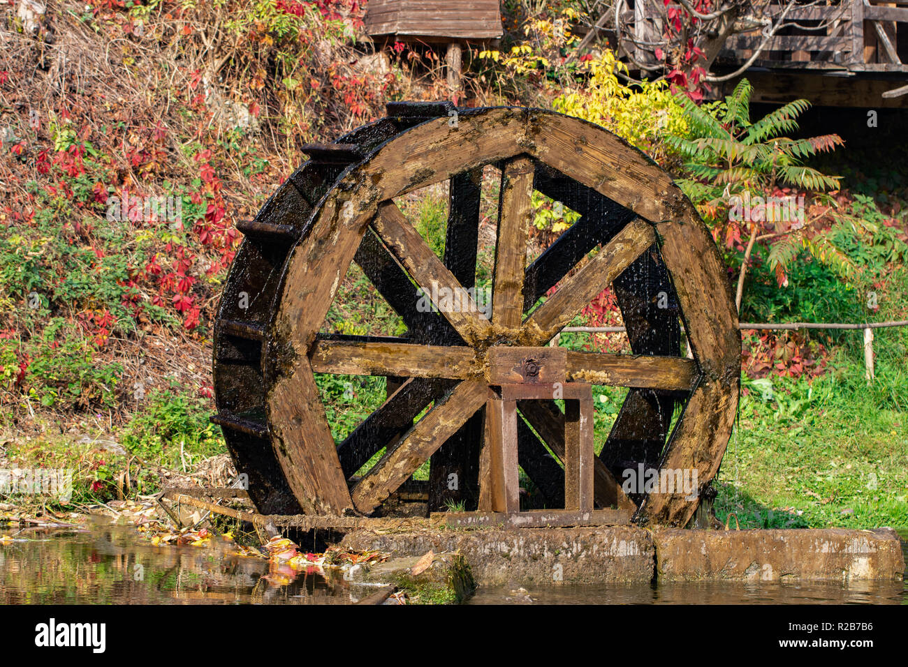 Working watermill wheel with falling water in the village Stock Photo -  Alamy