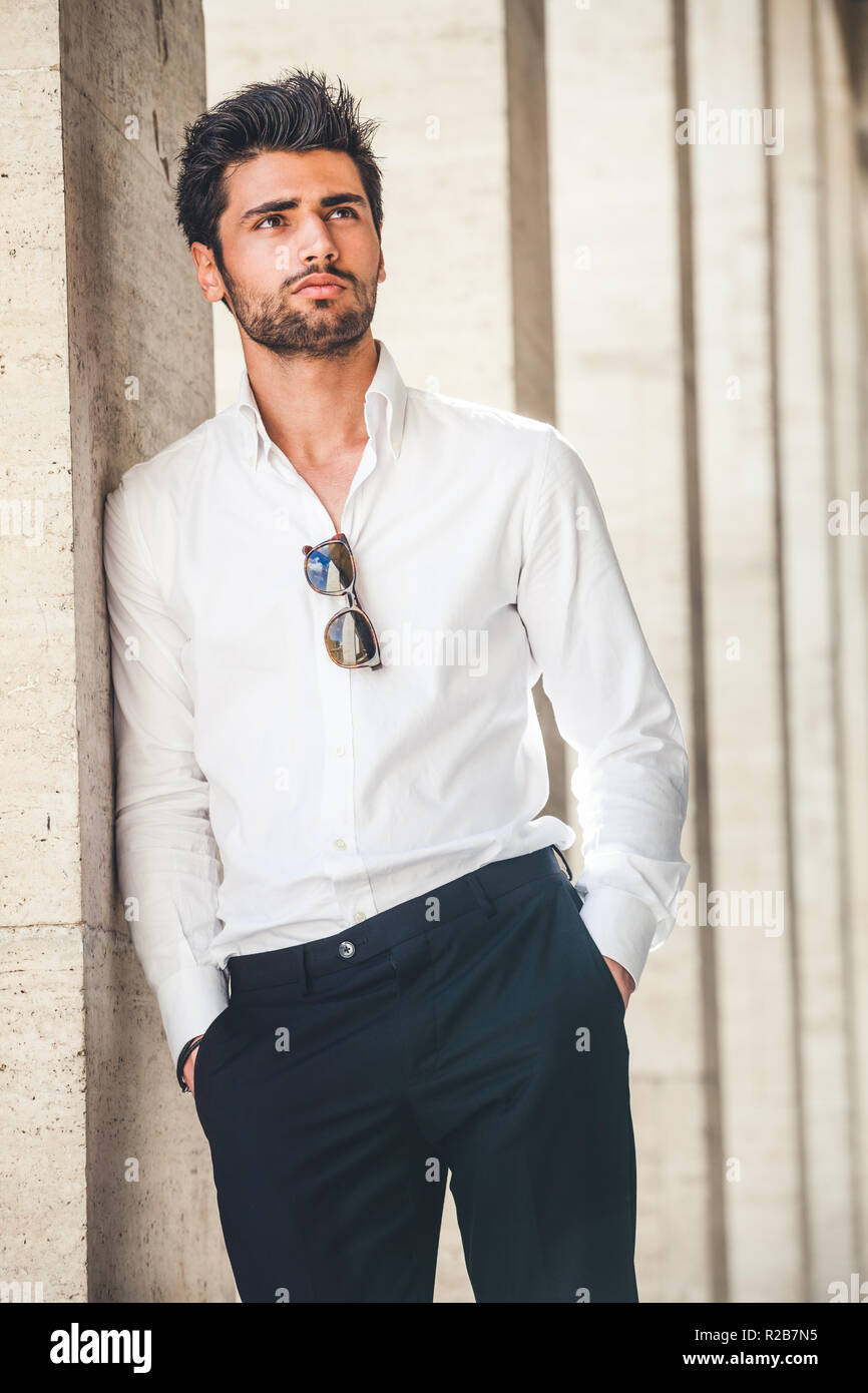 Portrait of young handsome man in white shirt outdoor. Nice
