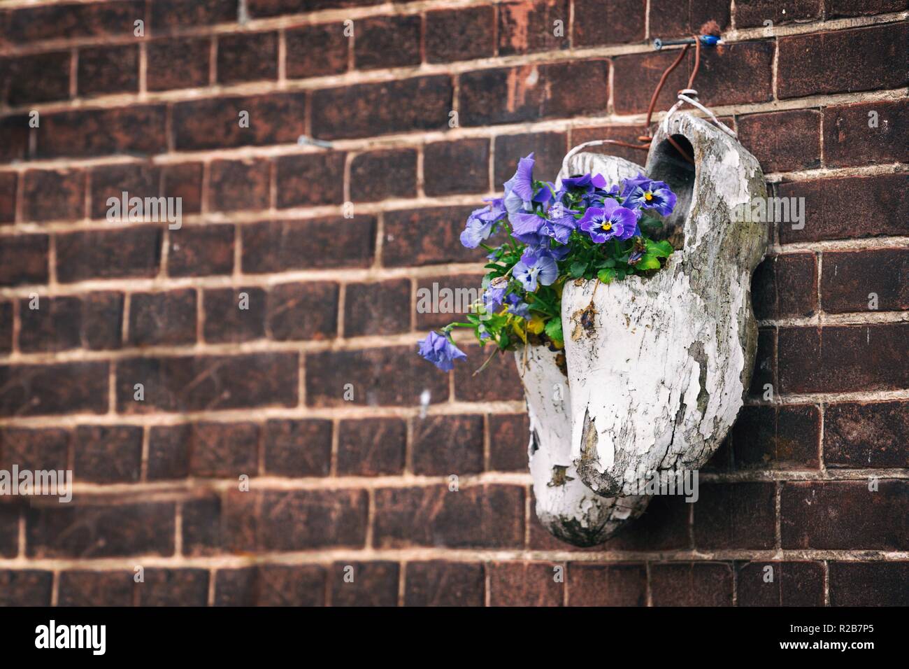 Garden Decor Old Wooden Klompen On Brick Wall Background Stock