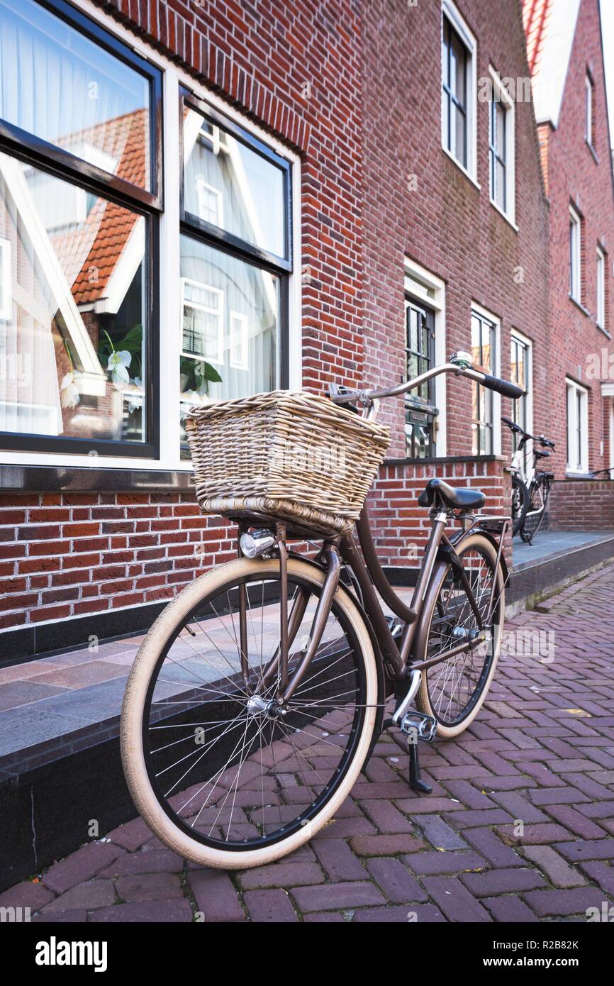 retro bike with basket standing on a street of amsterdam Stock Photo