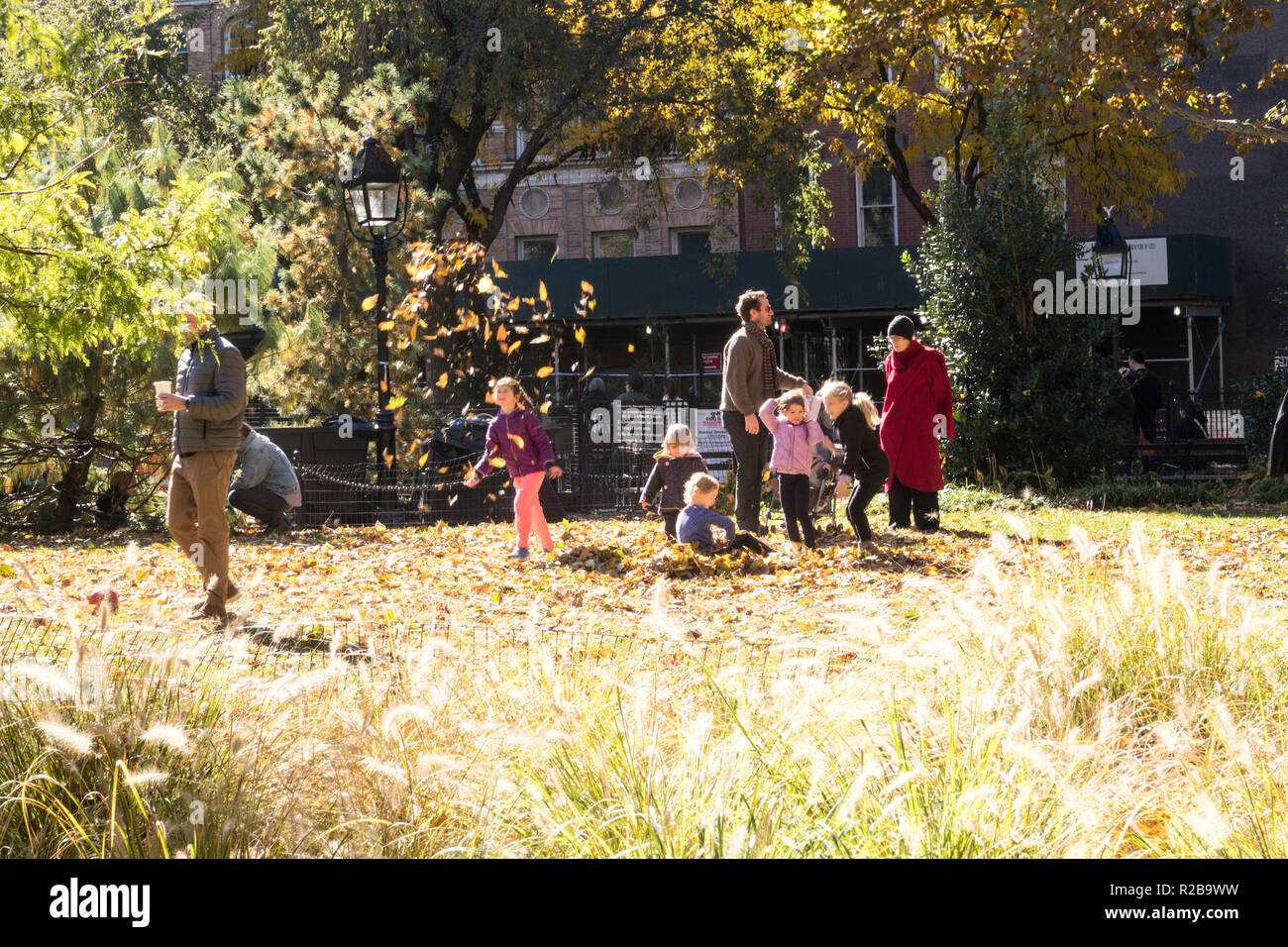 People Enjoying a Sunny Fall Day in Washington Square Park, NYC Stock Photo