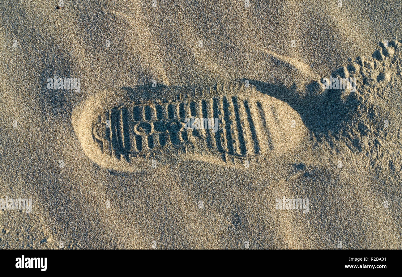 Geox brand shoe footprint on the sand of a beach Stock Photo