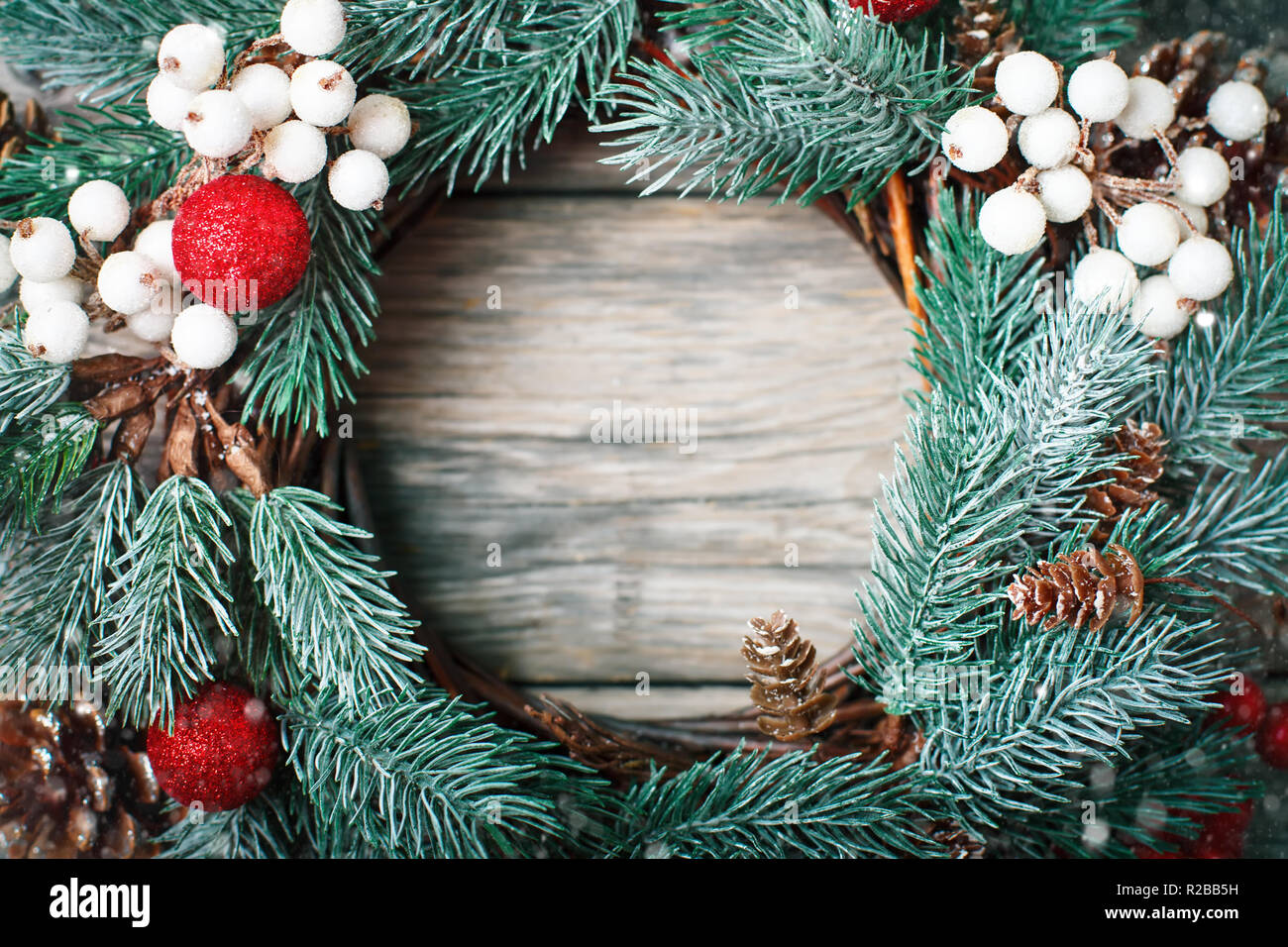 Merry Christmas and happy New year. Christmas decorative wreath on wooden background. Background with copy space. Horizontal. Selective focus. Stock Photo