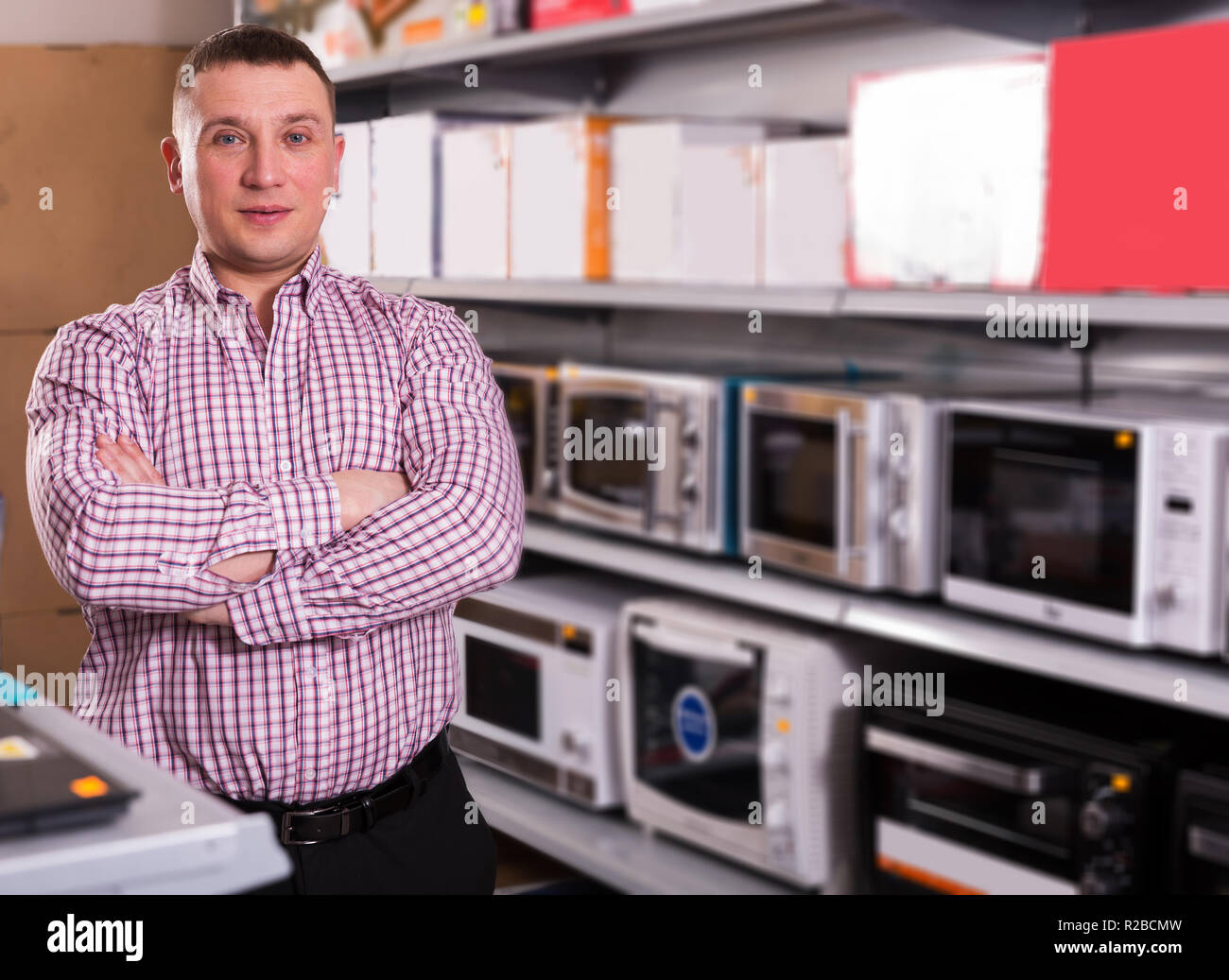 Middle-class  man choosing new microwave   in appliances store Stock Photo
