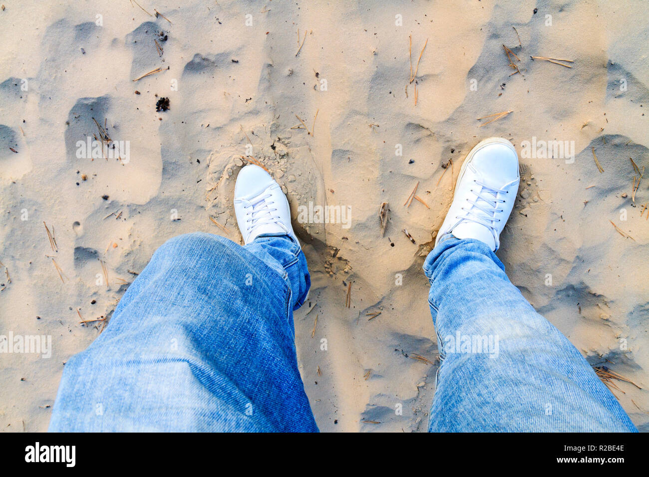 walk in the sand dunes in white shoes Stock Photo Alamy