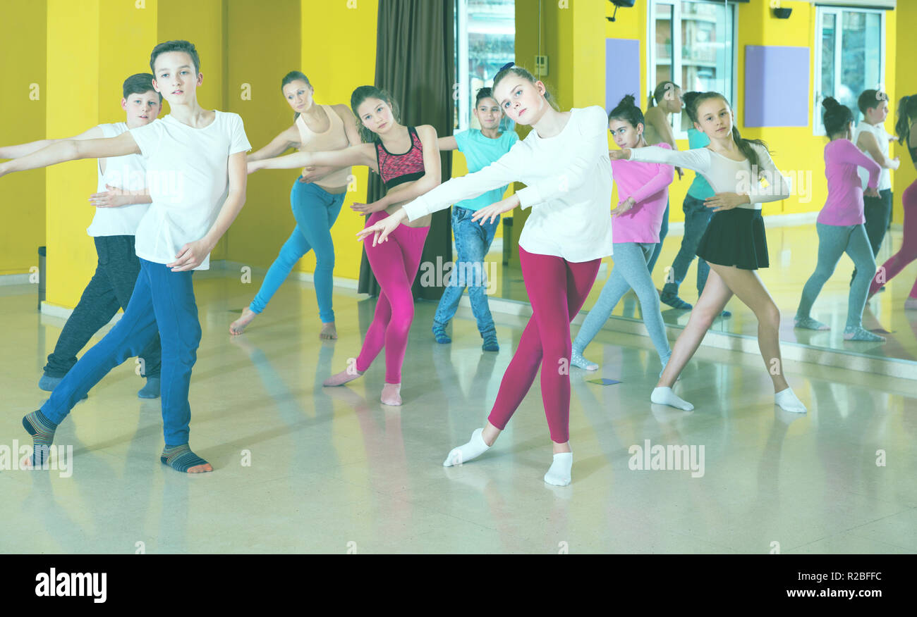 Happy cheerful smiling teenagers dancers practicing dance routine with ...