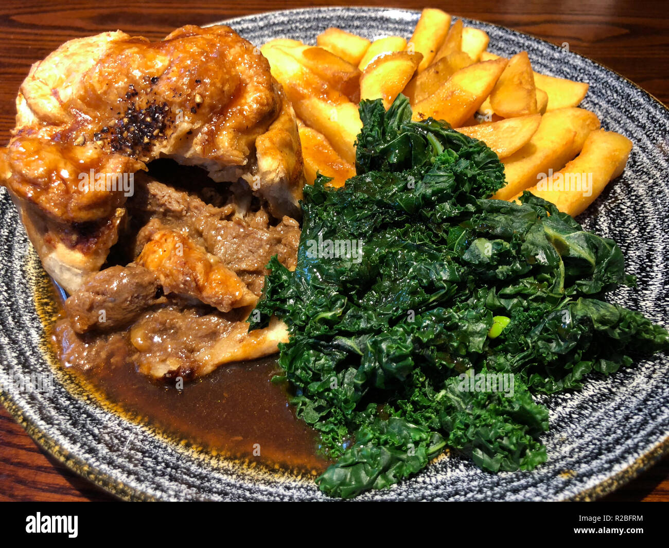 Steak pie with chips, cabbage and gravy Stock Photo Alamy
