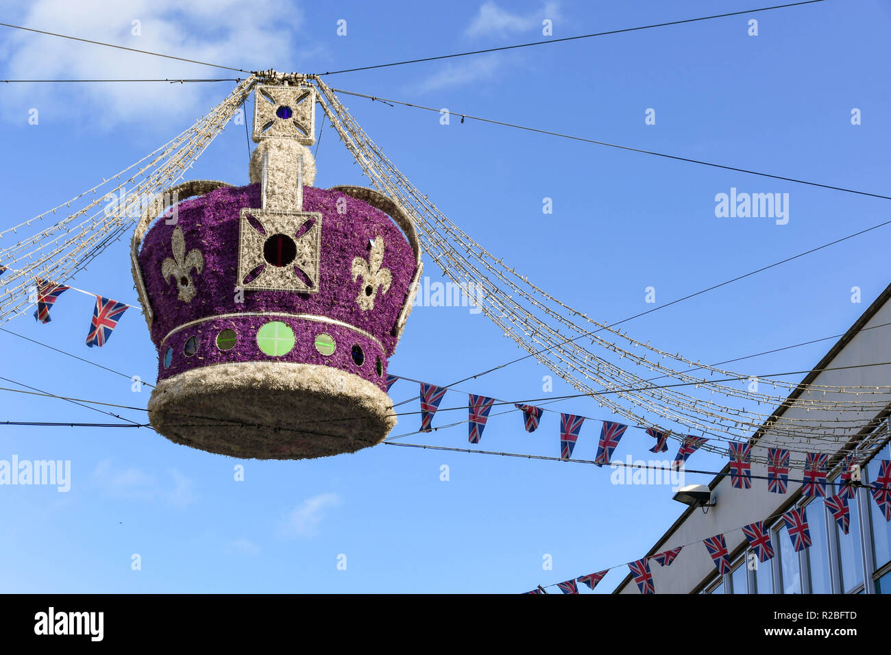 WINDSOR, ENGLAND - NOVEMBER 2018: Large regal crown suspended from wires over a street in Windsor town centre as part of its Christmas decorations. Stock Photo