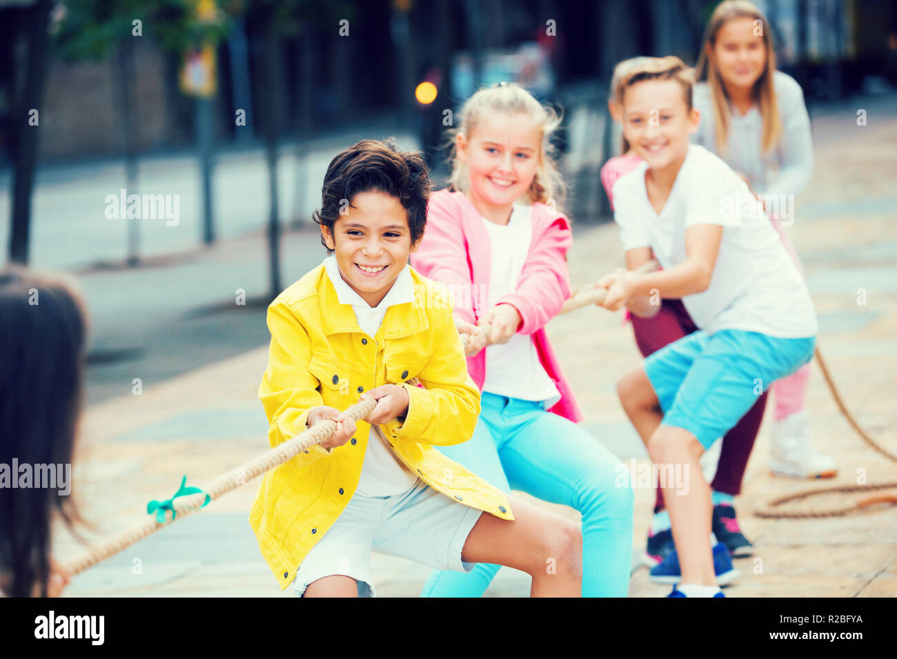 Children are pulling rope in the park Stock Photo - Alamy