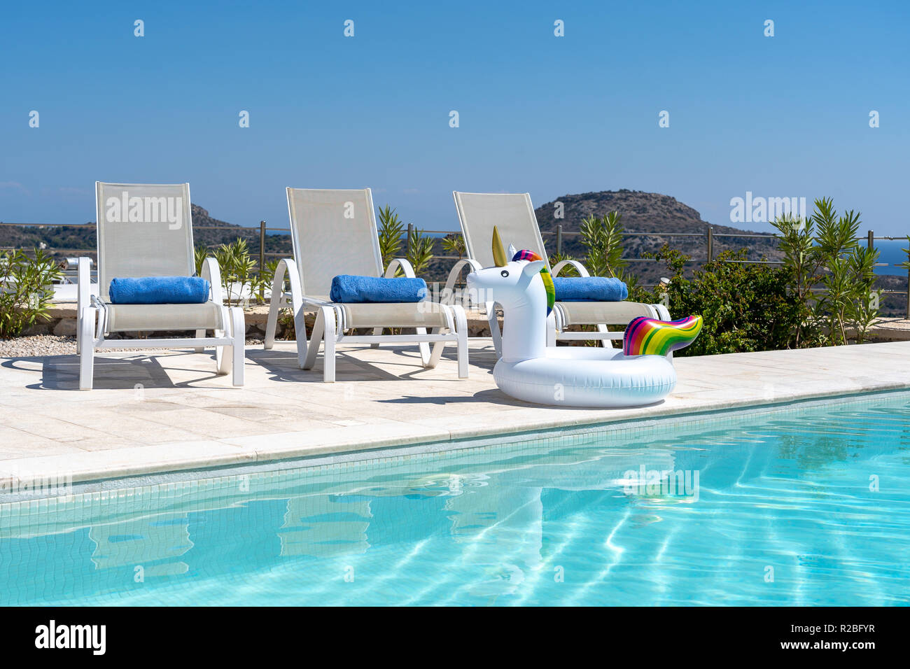 Sunloungers beside the pool Stock Photo