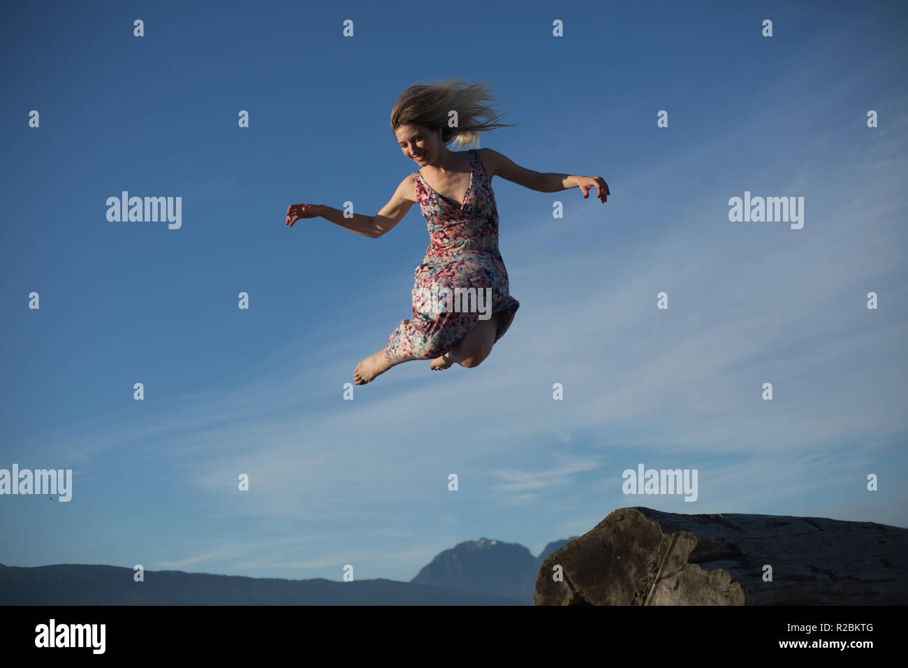 Happy beautiful woman flying ever mountains Stock Photo