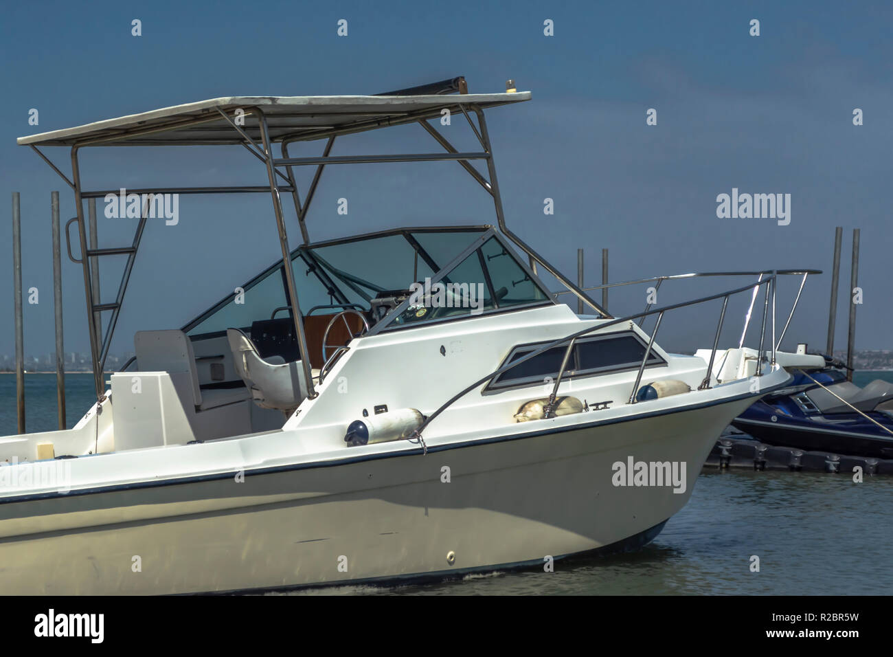 General exterior view of private recreational boat, parked at the beach in Mussulo island, Angola Stock Photo