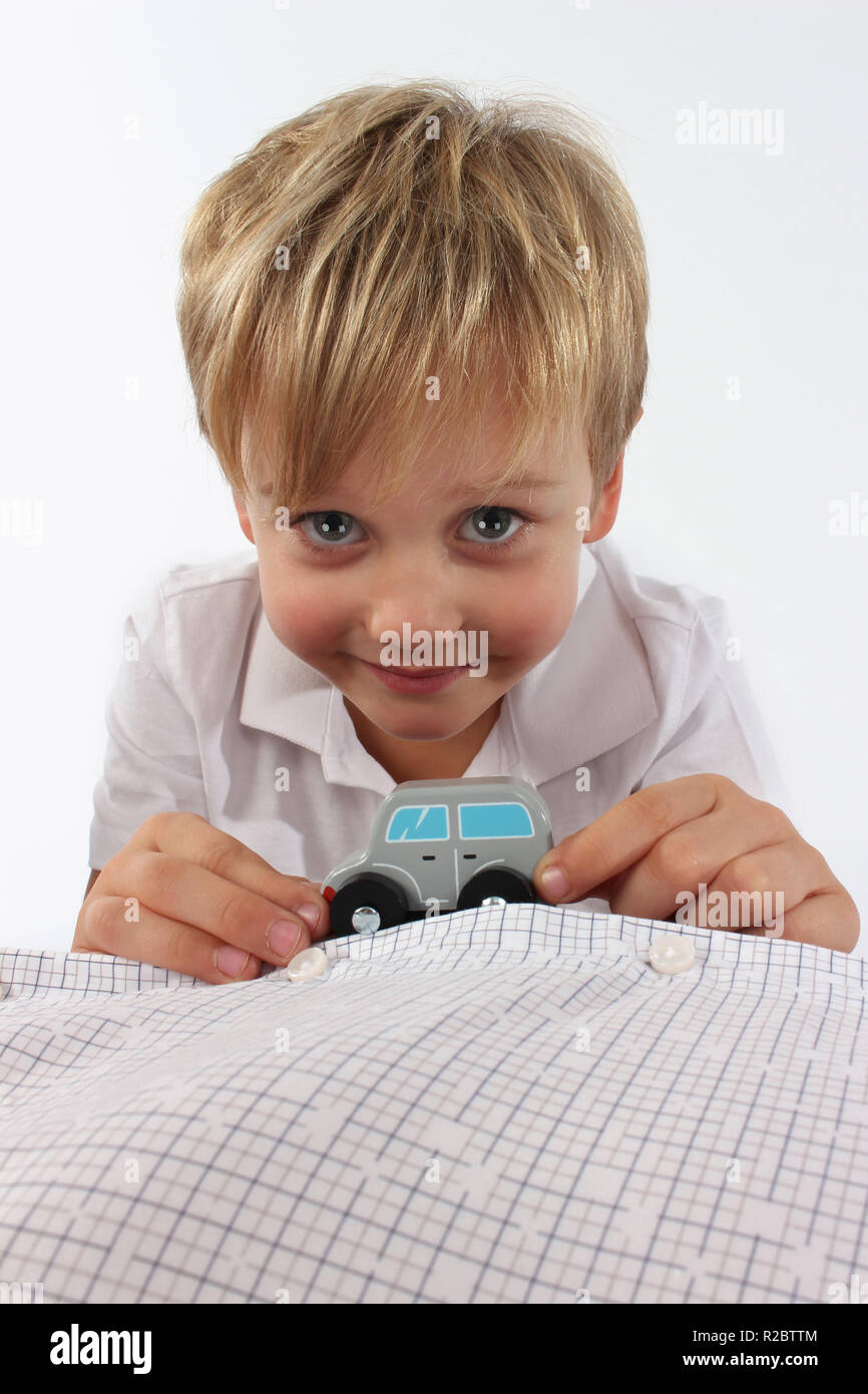 Adorable little boy playing with a small wooden car toy Stock Photo - Alamy