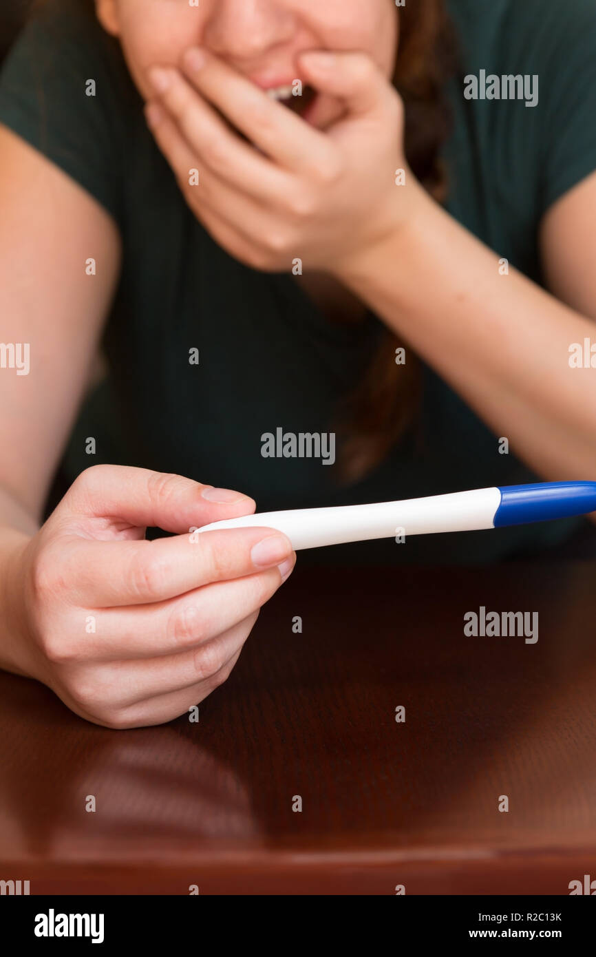 Happy Mom Looking at Home Pregnancy Test Results Stock Photo