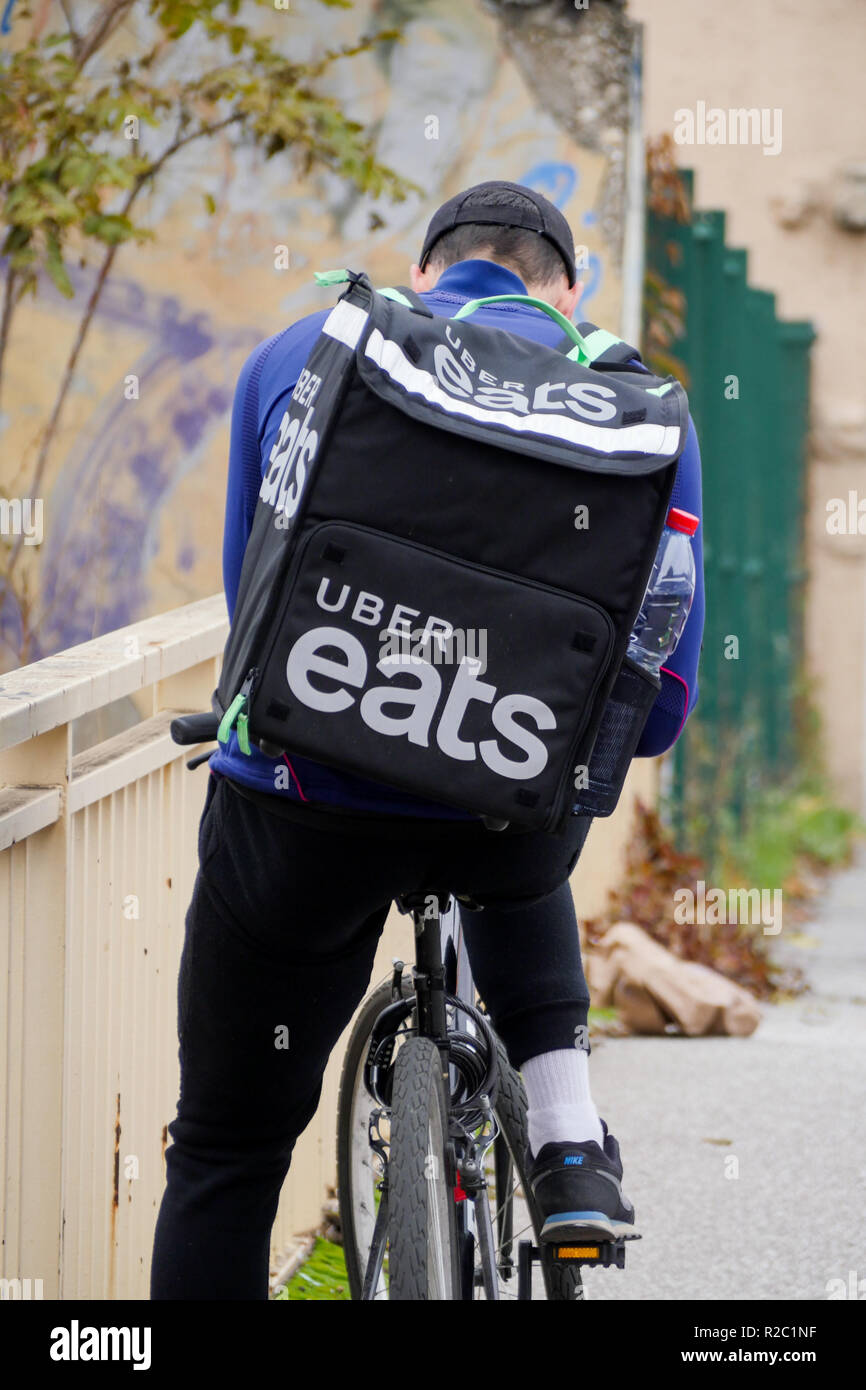 Uber Eats meal deliverer rides in Lyon, France Stock Photo