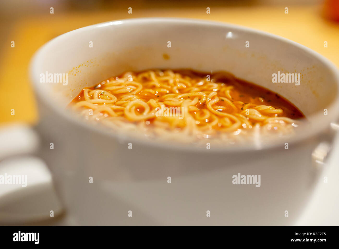 Hot spicy noodle soup closeup with out of focus elements Stock Photo