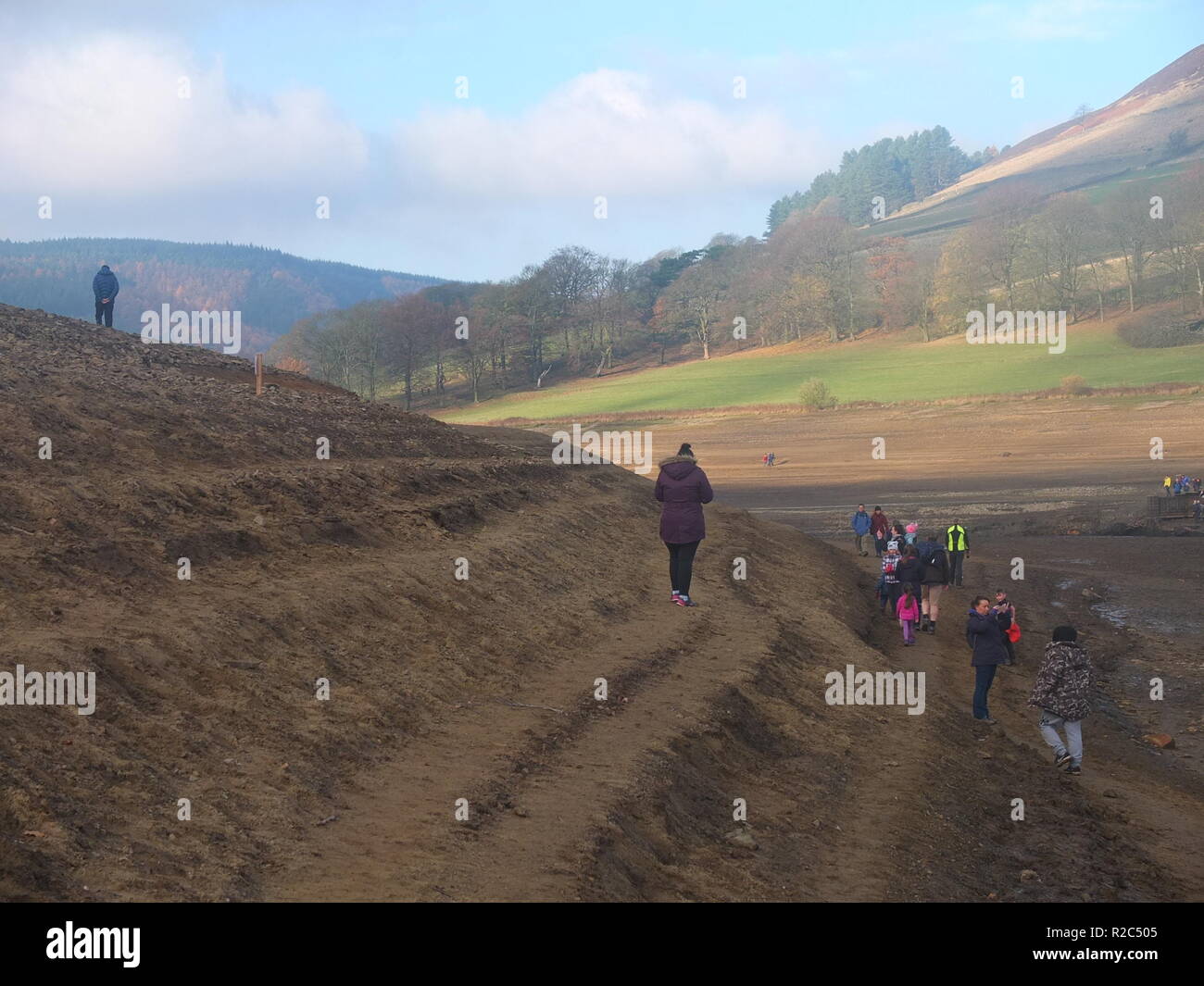 Curious crowds descend what are normally the banks of Ladybower Reservoir to explore remains of Derwent Village, exposed following 2018 heatwave Stock Photo