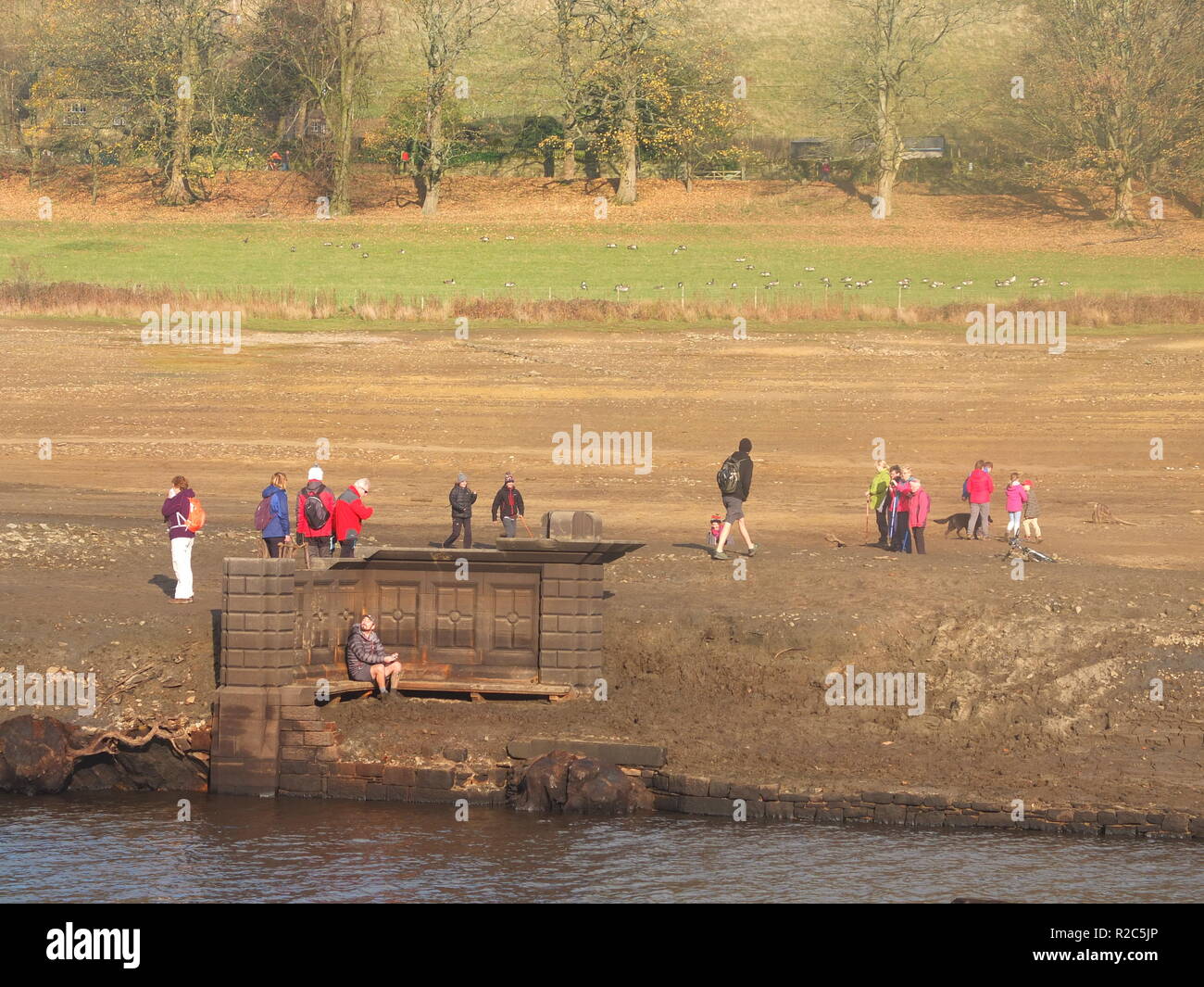 Curious crowds descend to what is normally the bottom of Ladybower Reservoir to explore remains of Derwent Village, exposed following 2018 heatwave Stock Photo