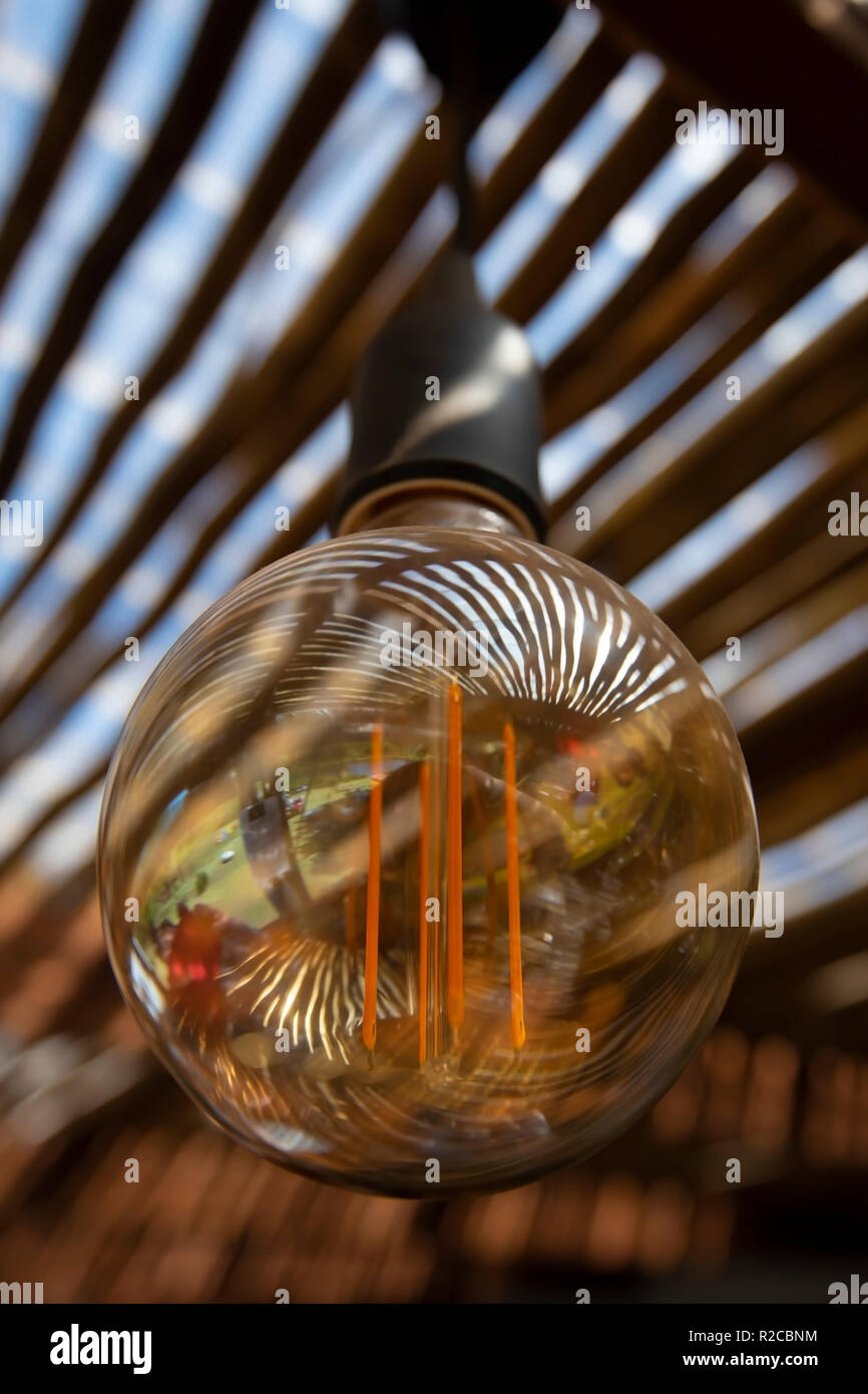 Reflections on the surface of an energy saving LED light bulb create beautiful patterns. Stock Photo
