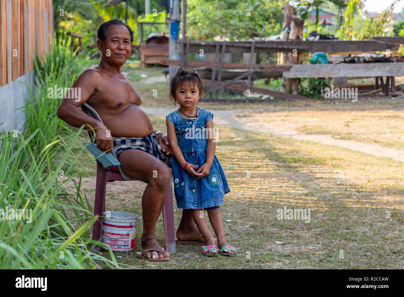 Don Det, Laos April 24, 2018 Local senior man sitting on a plastic