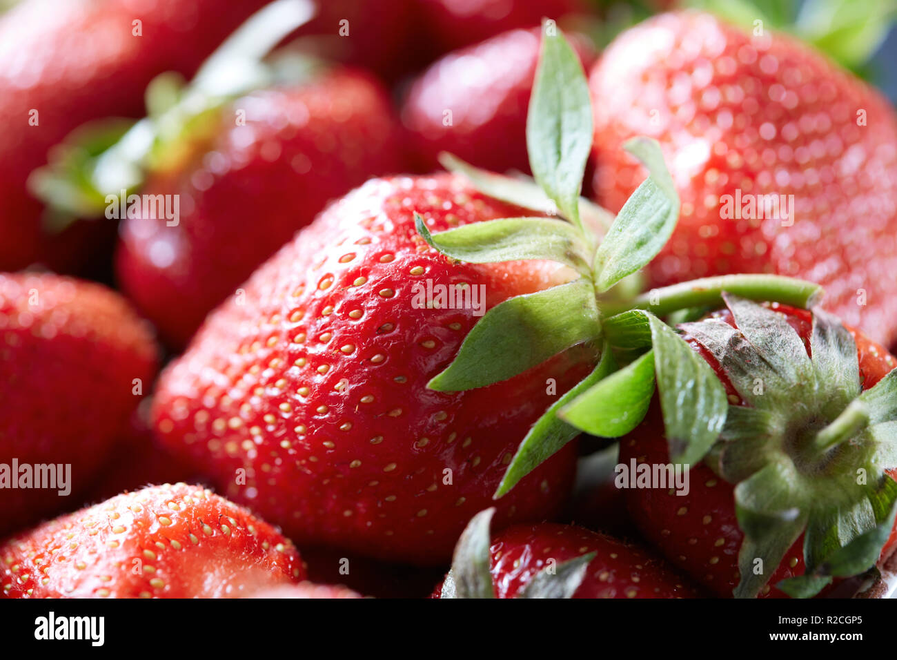 Macro photo of organic strawberries with green leaves. Healthy ...