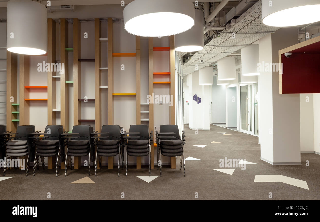 Modern office hall interior with stacks of chairs Stock Photo - Alamy