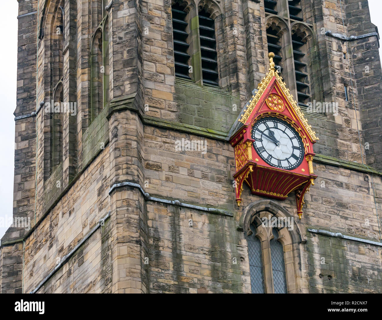 Unusual ornate wooden clock face on spire of St Nicholas cathedral