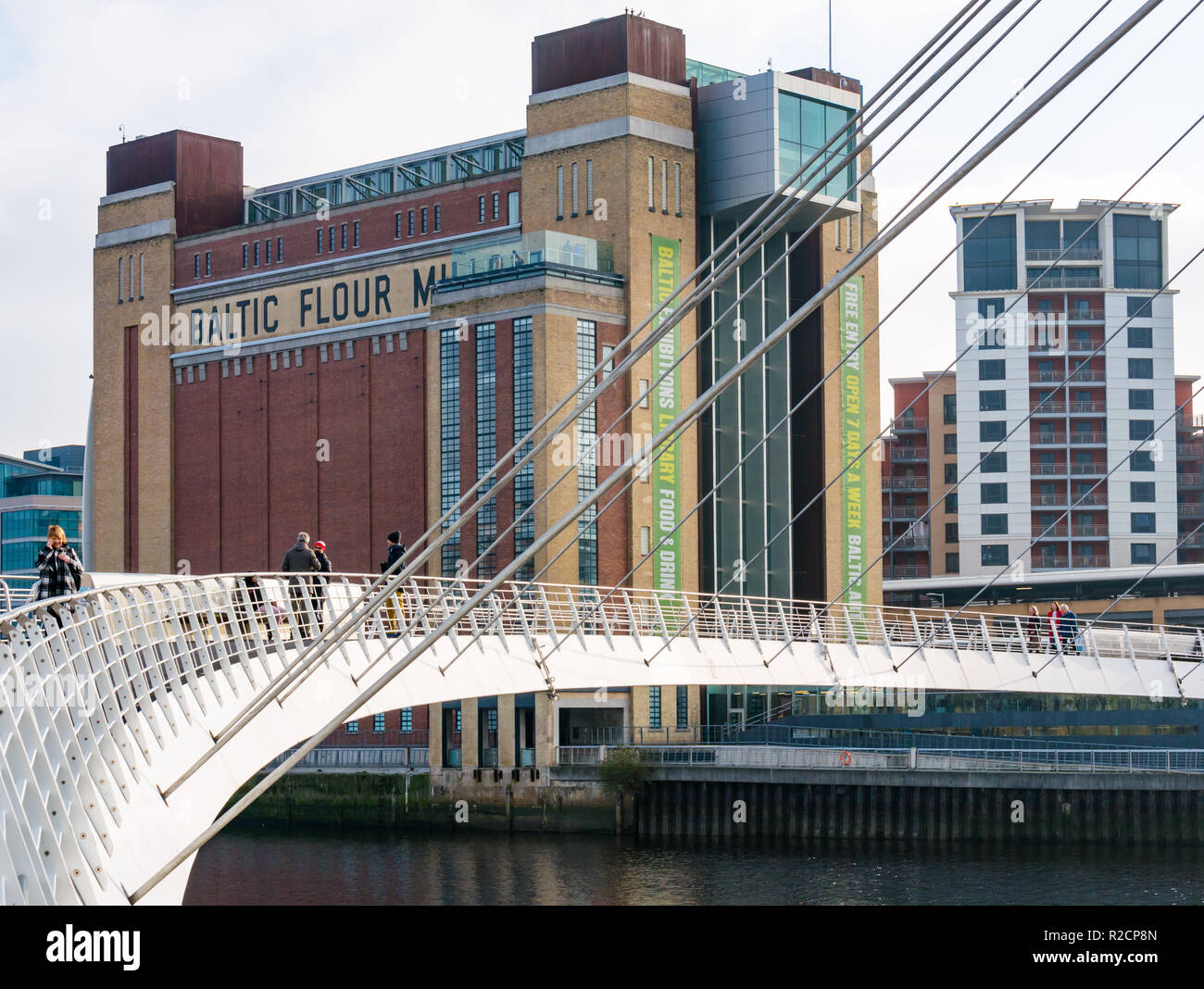 Baltic flour mill now art exhibition centre and pedestrian Gateshead Millennium Bridge, Newcastle Upon Tyne, England, UK Stock Photo