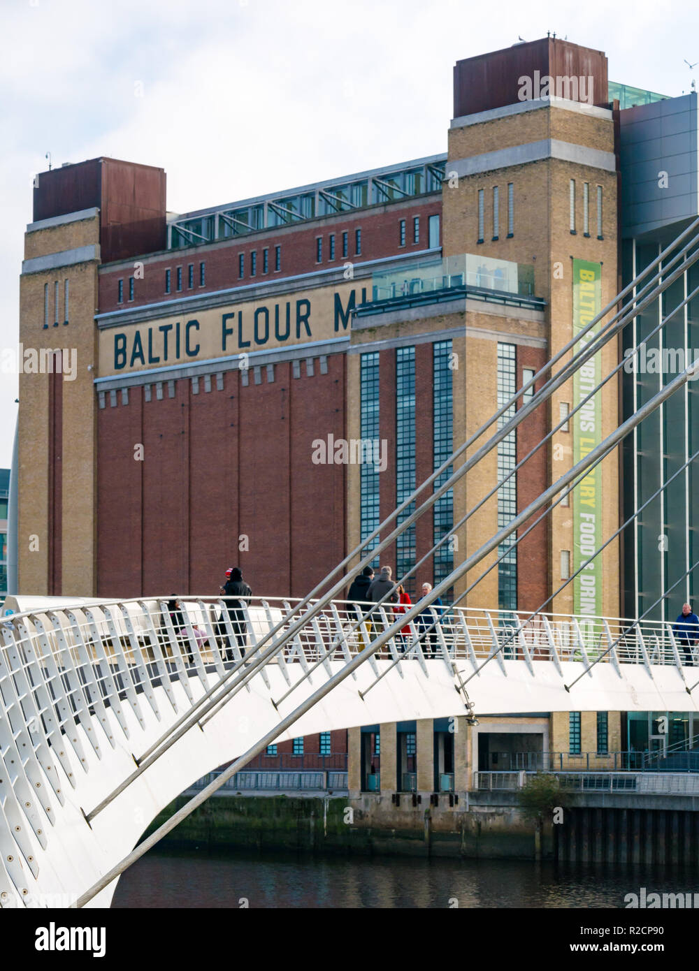 Baltic flour mill now art exhibition centre and pedestrian Gateshead Millennium Bridge, Newcastle Upon Tyne, England, UK Stock Photo