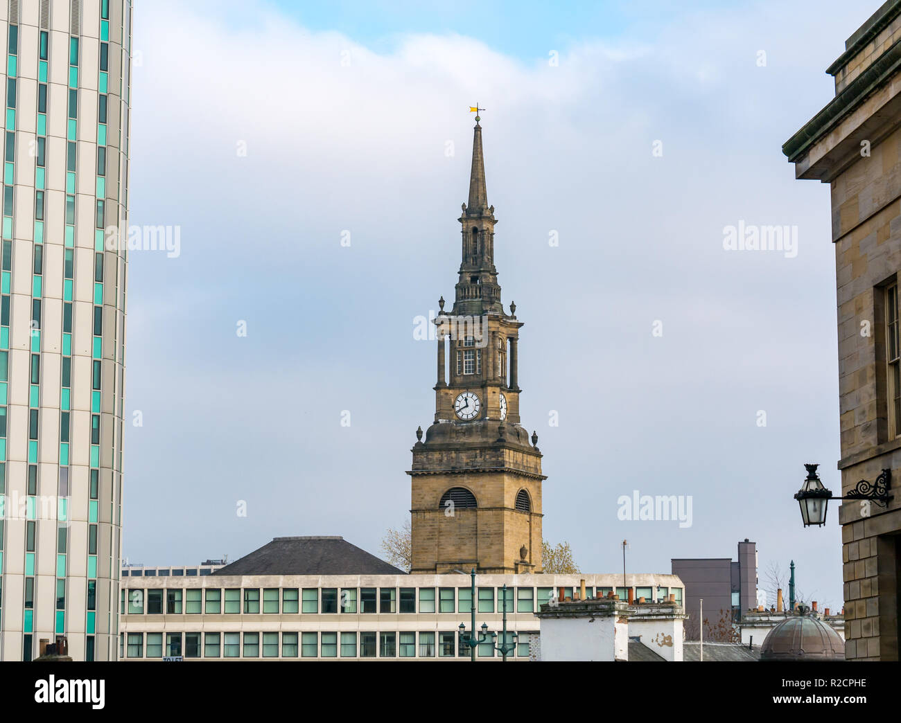 Church of Saint Willibrord with All Saints spire with modern office building, Newcastle Upon Tyne, England, UK Stock Photo
