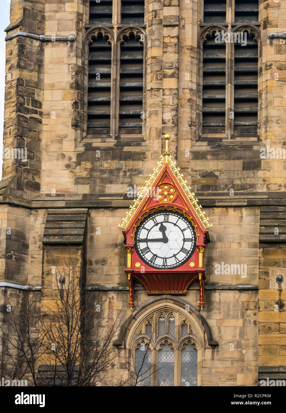 Unusual ornate wooden clock face on spire of St Nicholas cathedral