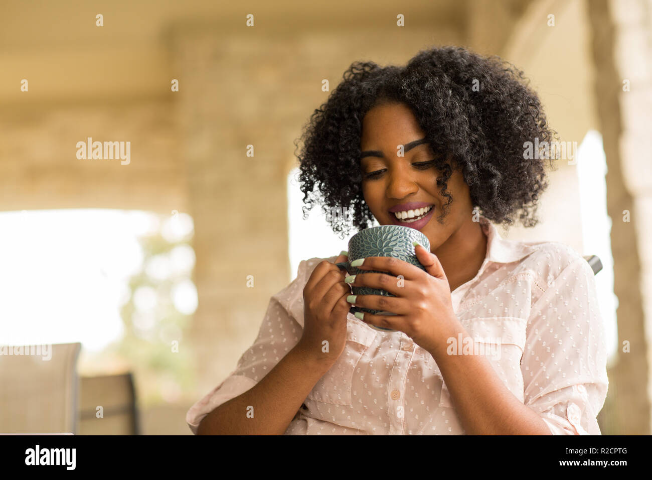 Portrait of an African American woman drinking coffee Stock Photo - Alamy