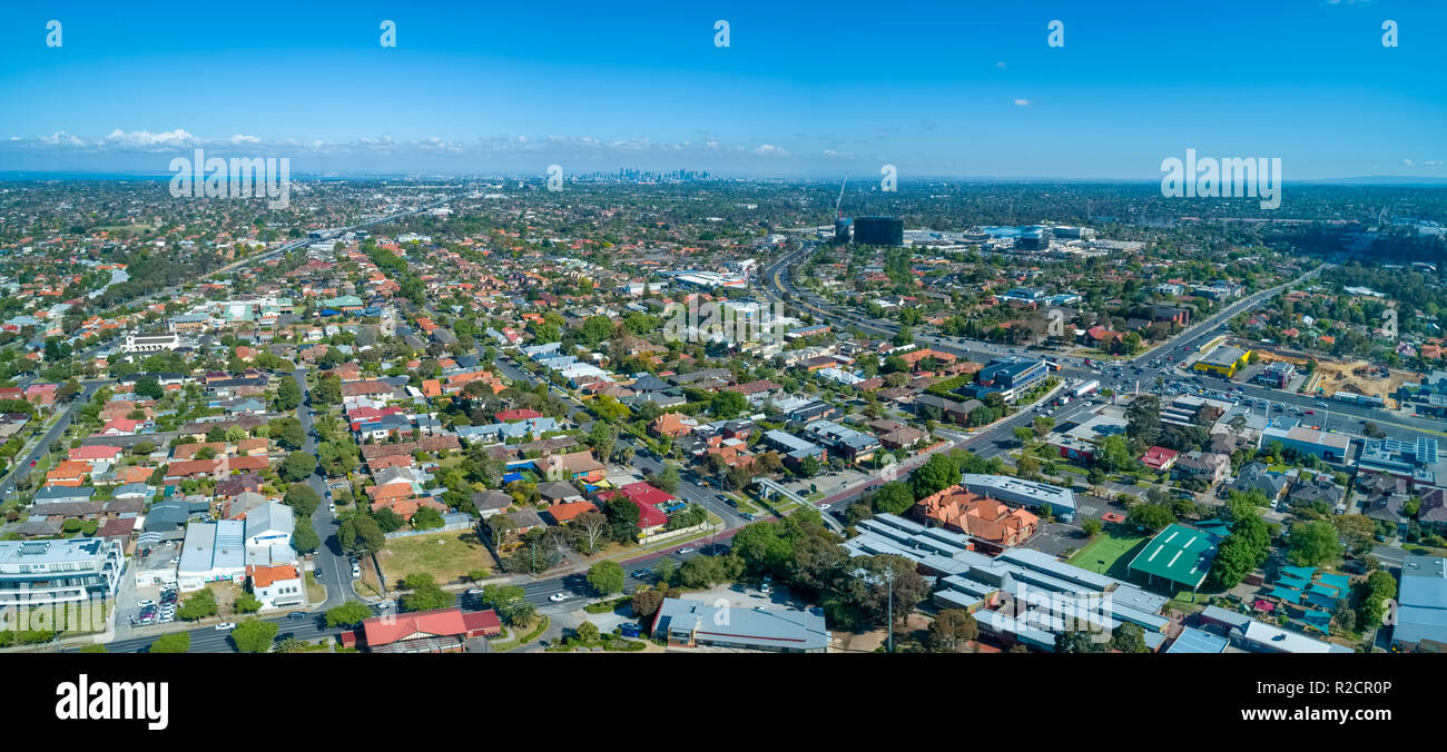 Wide aerial panorama of Oakleigh suburb with Melbourne CBD high rise buildings in the distance Stock Photo