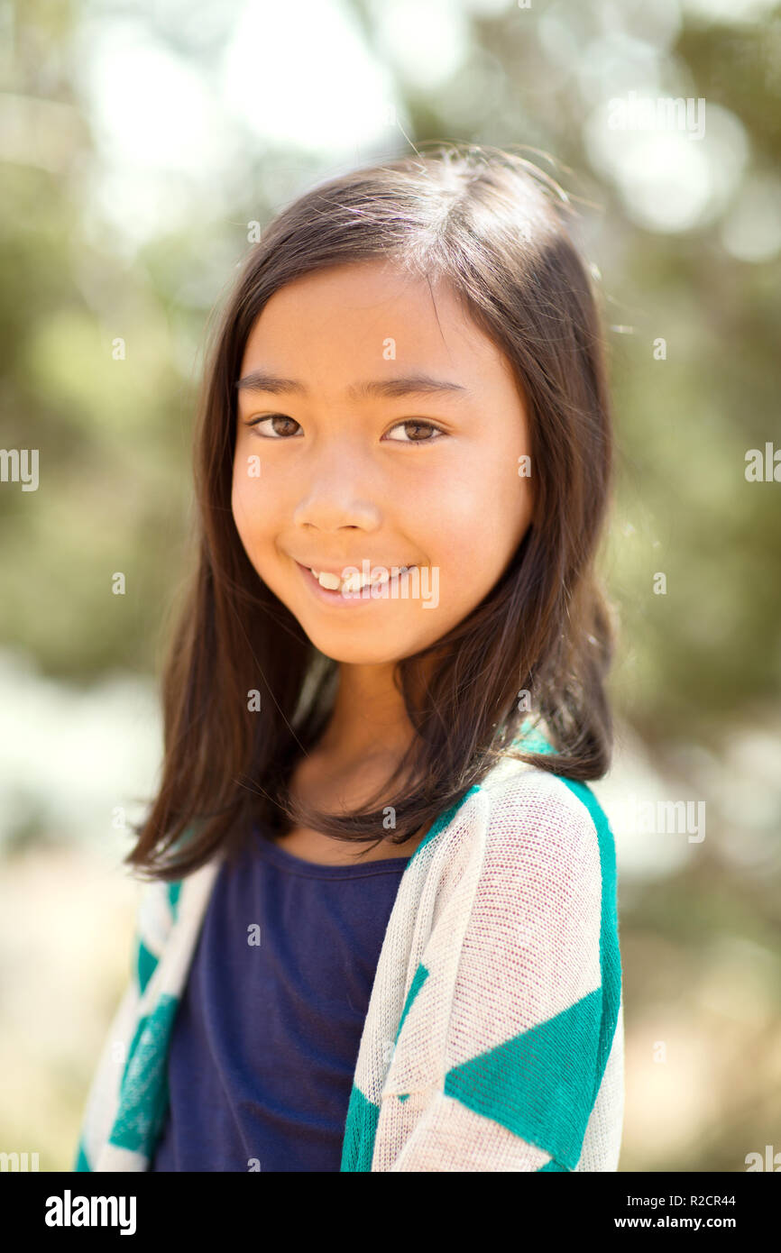 Portrait of a young asian girl smiling outside. Stock Photo