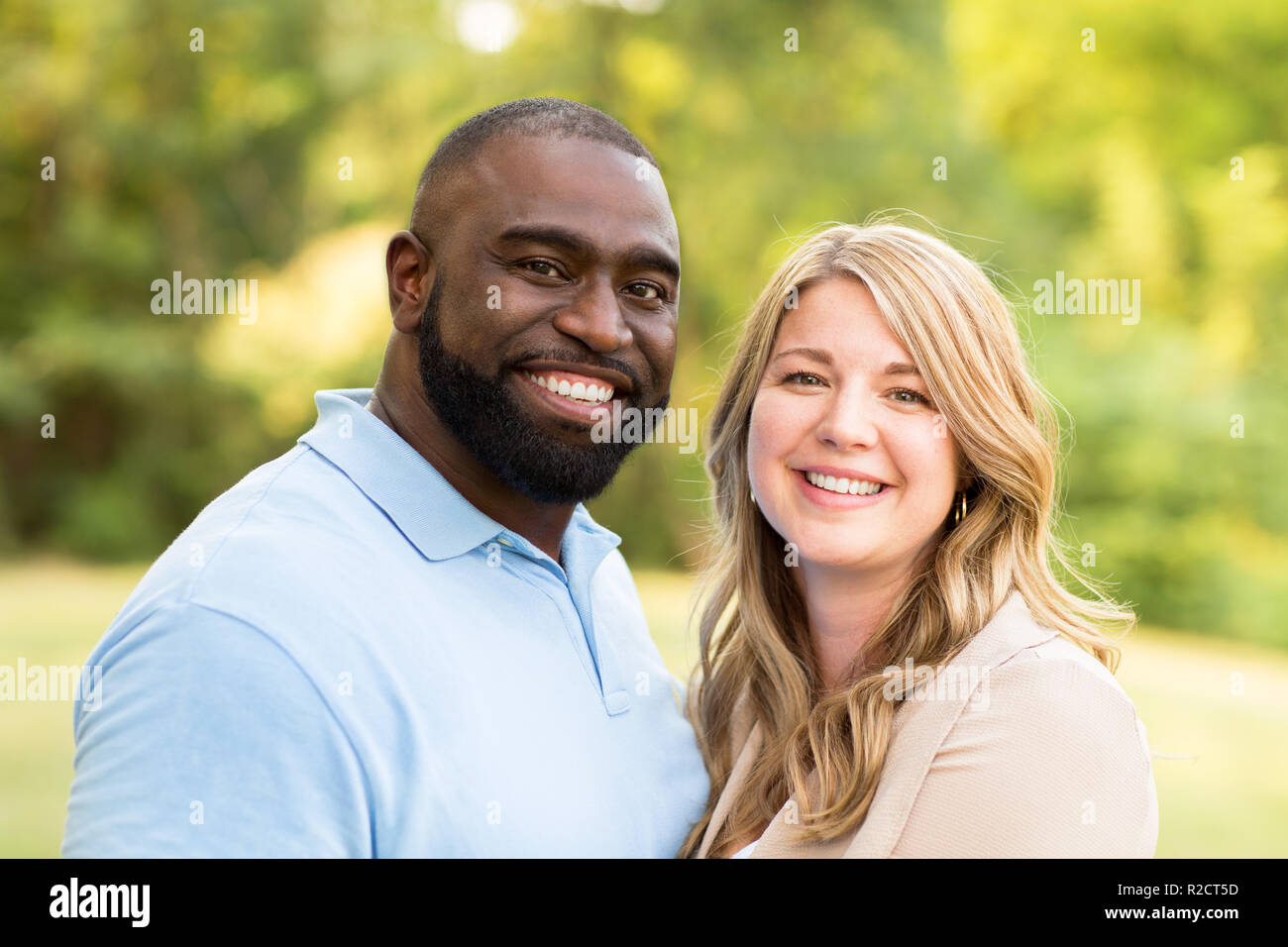 Loving mixed race couple hugging and laughing Stock Photo - Alamy