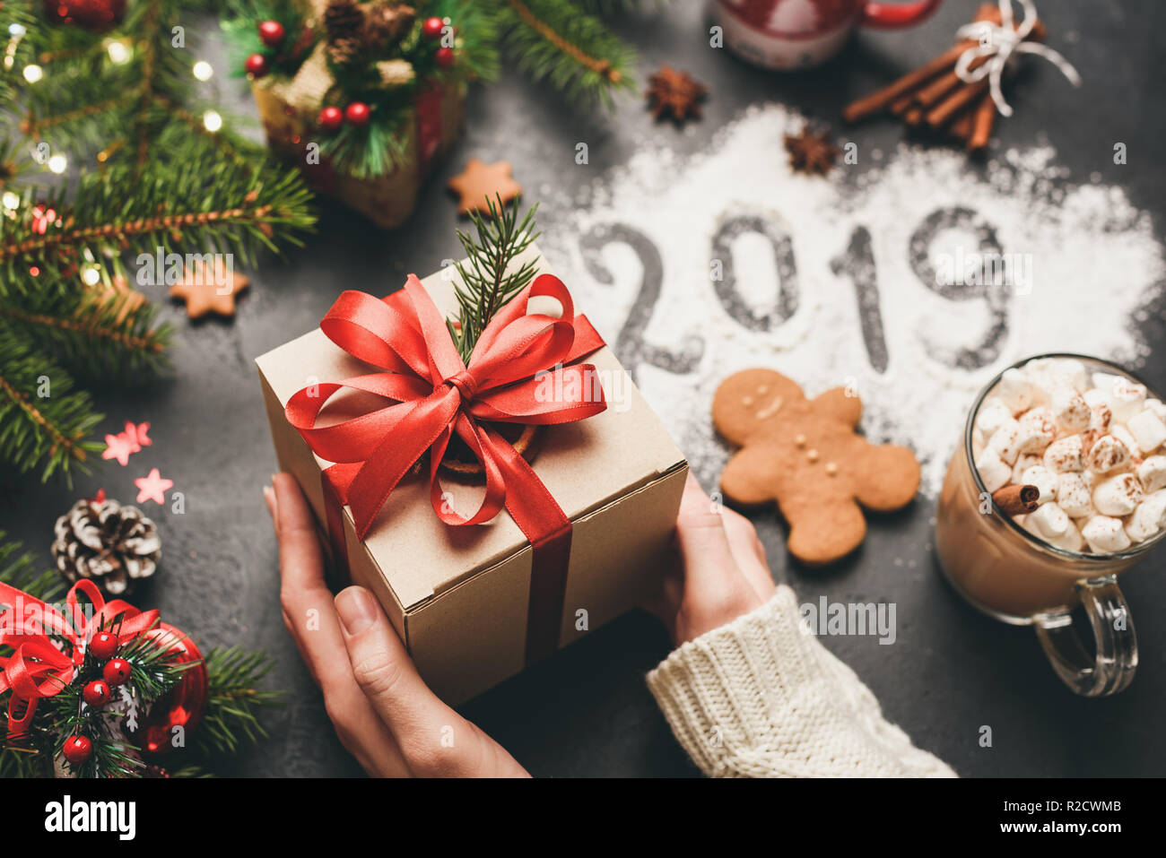 Christmas or New Year 2019 Hands Holding Gift Box. Happy New Year or Merry Christmas concept, Winter Holidays Background Stock Photo
