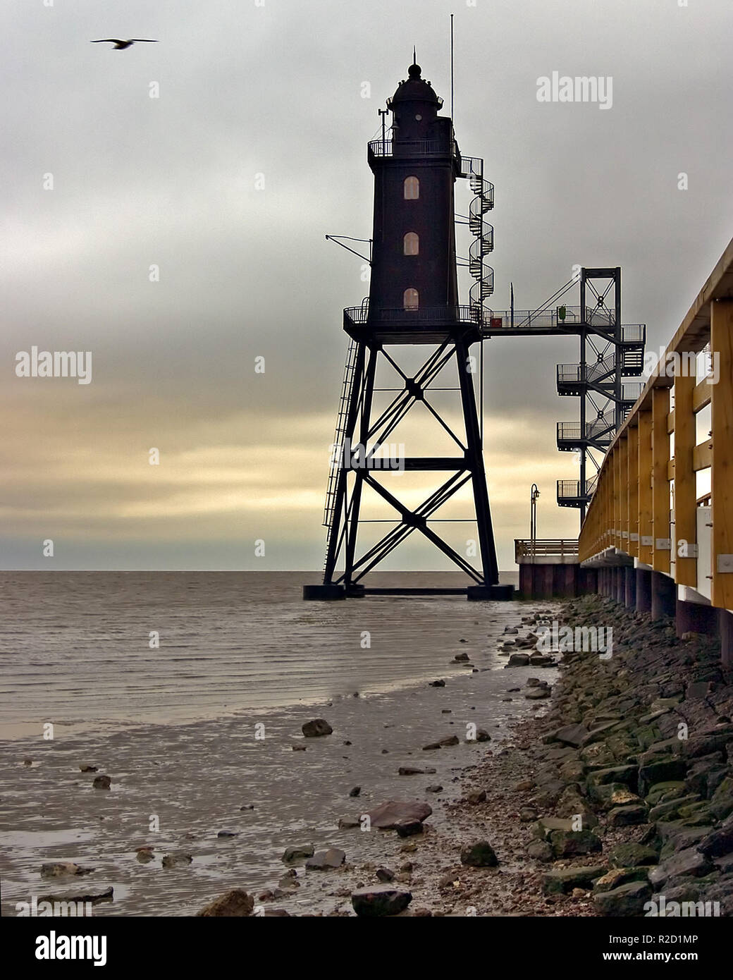 There is a bridge in front of the lighthouse hi-res stock photography ...