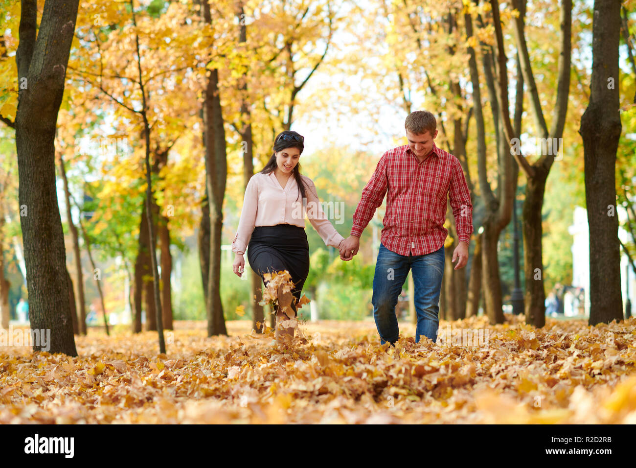 Couple is walking in autumn city park. Bright yellow trees Stock Photo ...