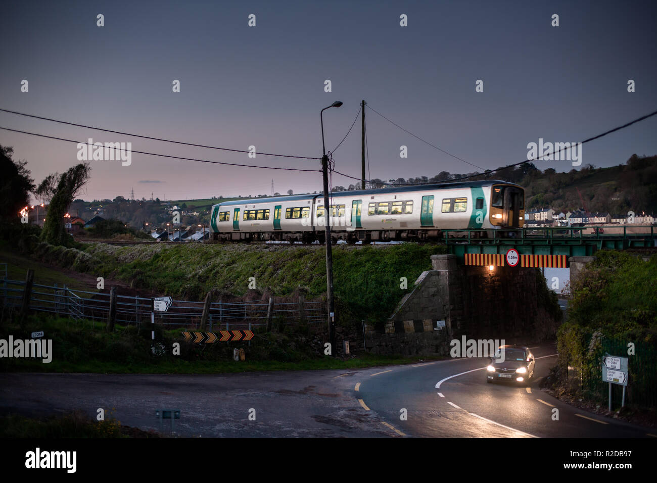 Rushbrooke, Cork, Ireland. 19th November, 2018. An early morning commuter train from Cobh passes over a road at Rushbrooke, Co. Cork, Ireland. Credit: David Creedon/Alamy Live News Stock Photo