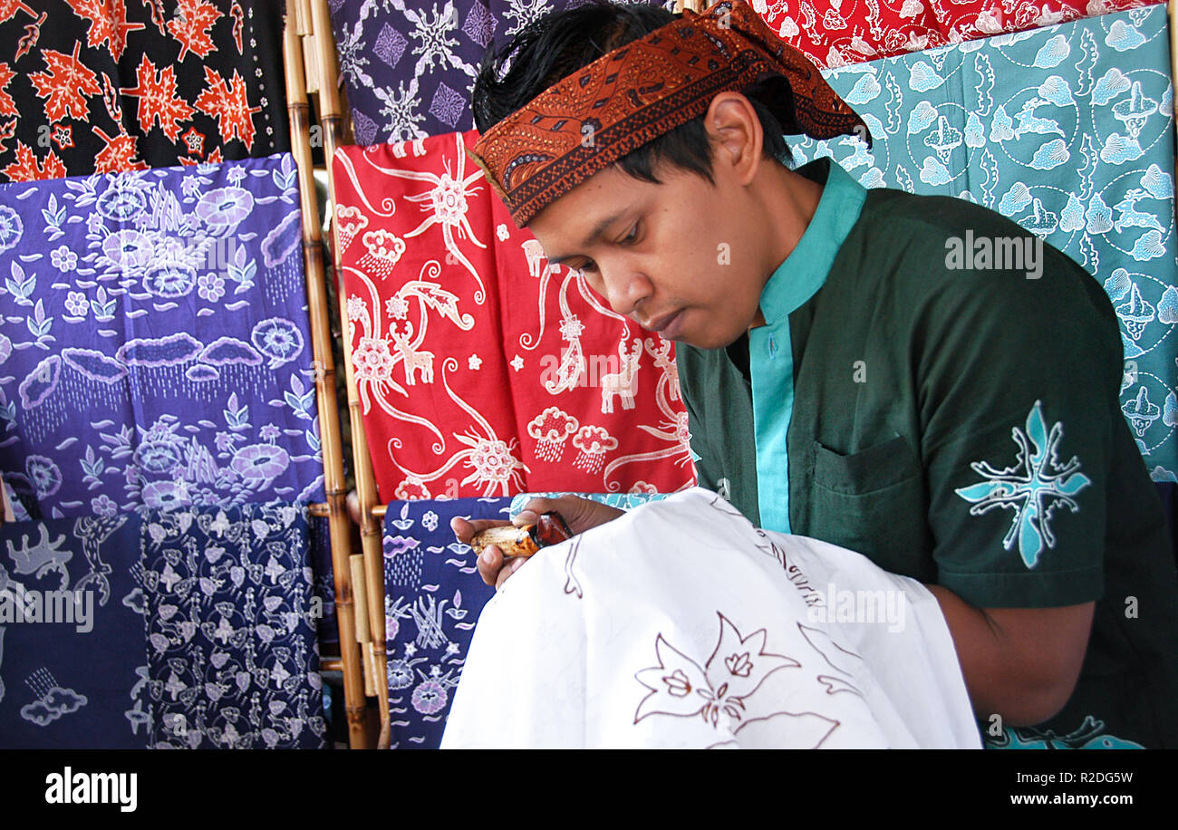 A man is seen painting motifs on a cloth in the traditional way at the Bogor batik gallery. Bogor batik cloth is a unique cleaver motif and drizzle, they are applied in batik strokes that are part of the symbol of the City of Bogor and the deer head motif which is a symbol of the Bogor Palace while the lotus motif is a symbol of the Bogor Botanical Garden, the kujang knife as the symbol of the city of Bogor and the rain motif as the term Bogor city. UNESCO awarded Indonesia batik as a Humanitarian Heritage for Oral and Non-Cultural Heritage (Masterpieces of the Oral and the Intangible Heritage Stock Photo