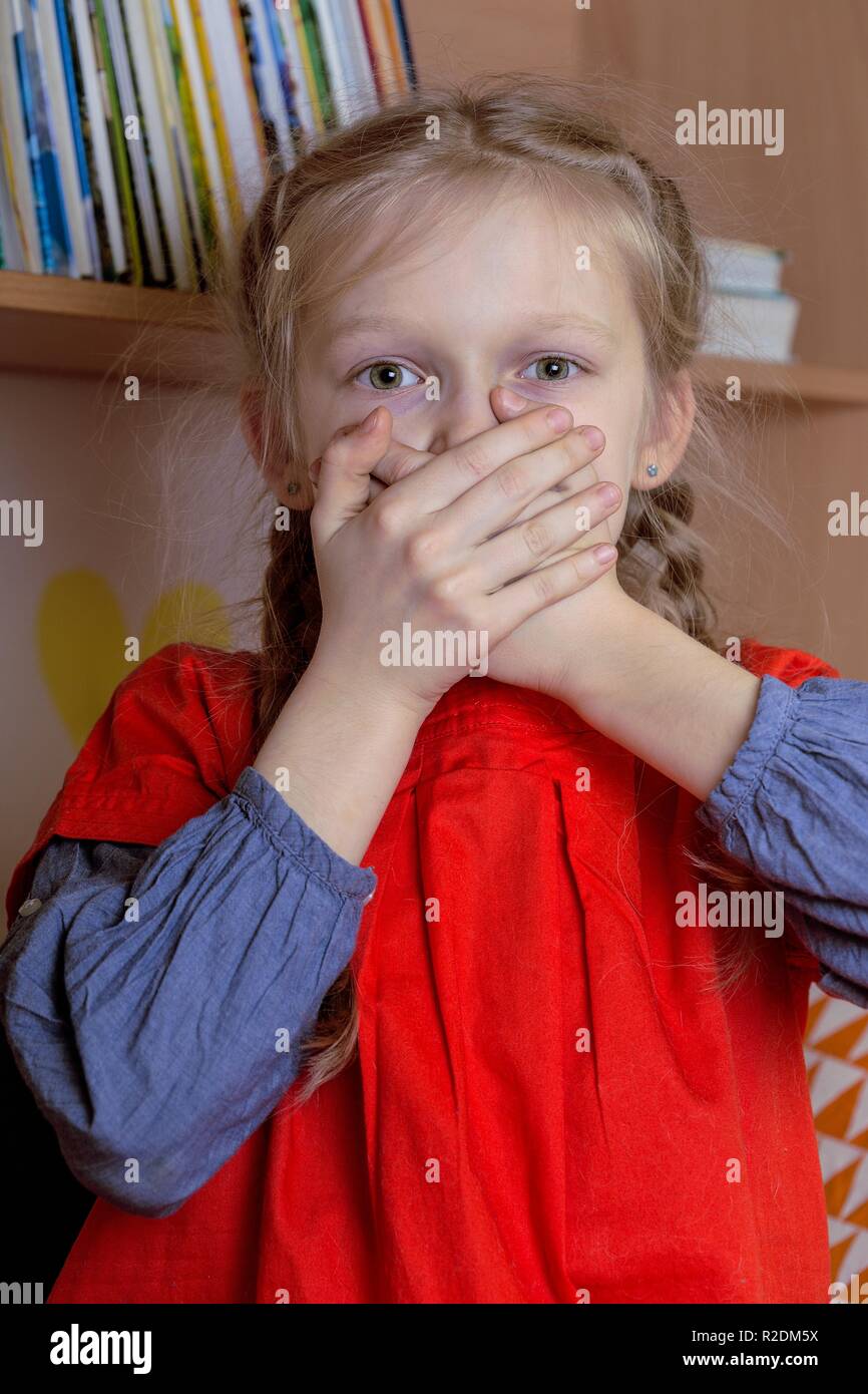 little girl is scared watching TV Stock Photo