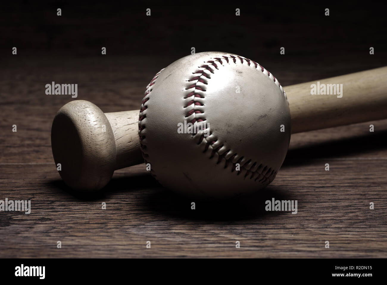 Retro baseball and bat in locker room on wooden bench Stock Photo