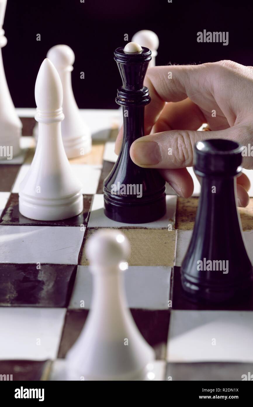 Detail of a woman's hand in a chess game Stock Photo - Alamy