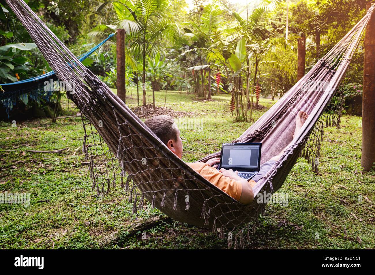 Man lying in a hammock hi-res stock photography and images - Alamy