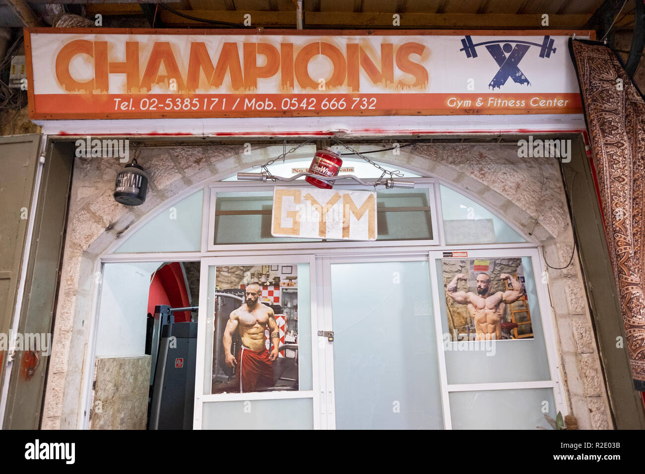 The exterior of CHAMPIONS GYM in the Old City of Jerusalem with photos of bodybuilders in the window. Stock Photo