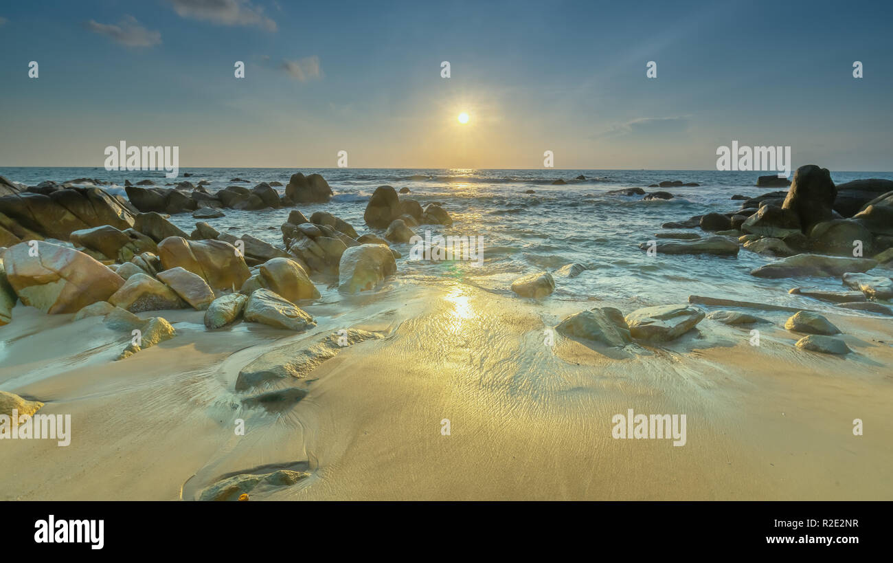 Sunrise ancient fossil reef as radiating star rounded up right edge large rock like shining pearl release, Stock Photo