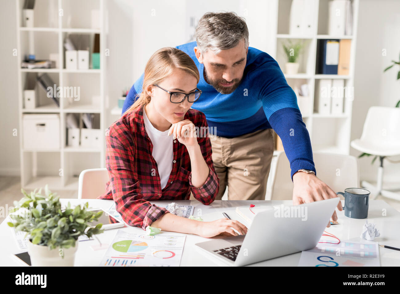 Concentrated programmers browsing internet while working on new  Stock Photo